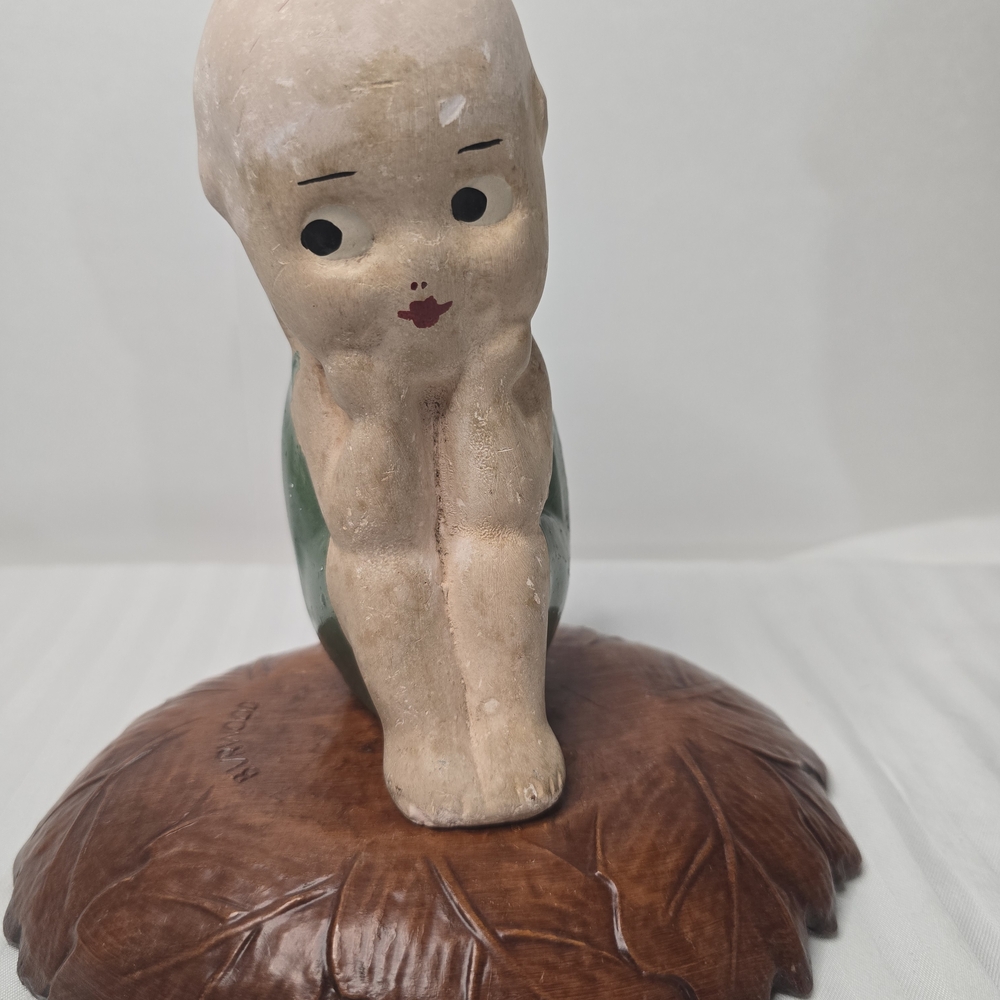 Adorable Ceramic Child Sculpture with Brown Base